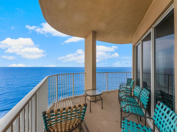 Corner wraparound balcony at Tidewater Beach Resort with panoramic Gulf of Mexico views and outdoor seating.