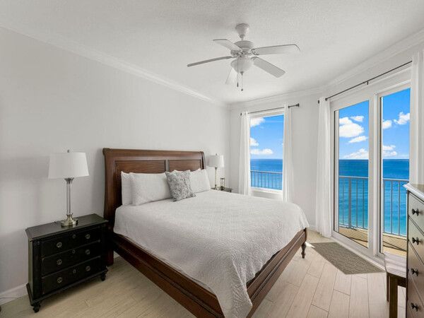Gulf-front bedroom at Grandview East Resort Condo with king bed, nightstands, and direct access to a private balcony overlooking the ocean.