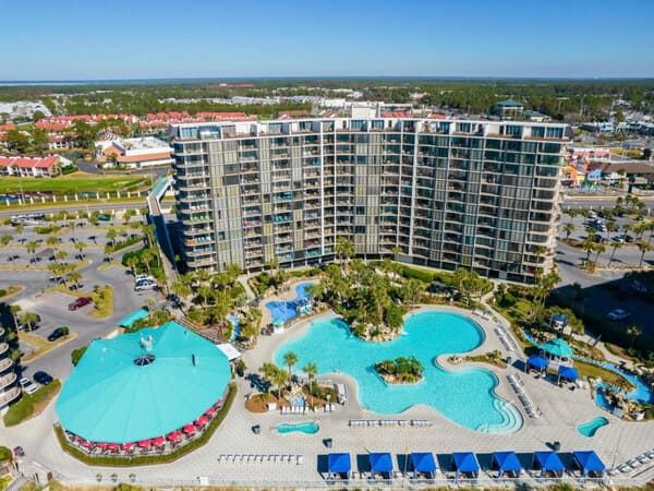 Aerial view of Edgewater Beach Resort showing the lagoon-style pool, beachfront location, and high-rise condo towers in Panama City Beach, Florida.