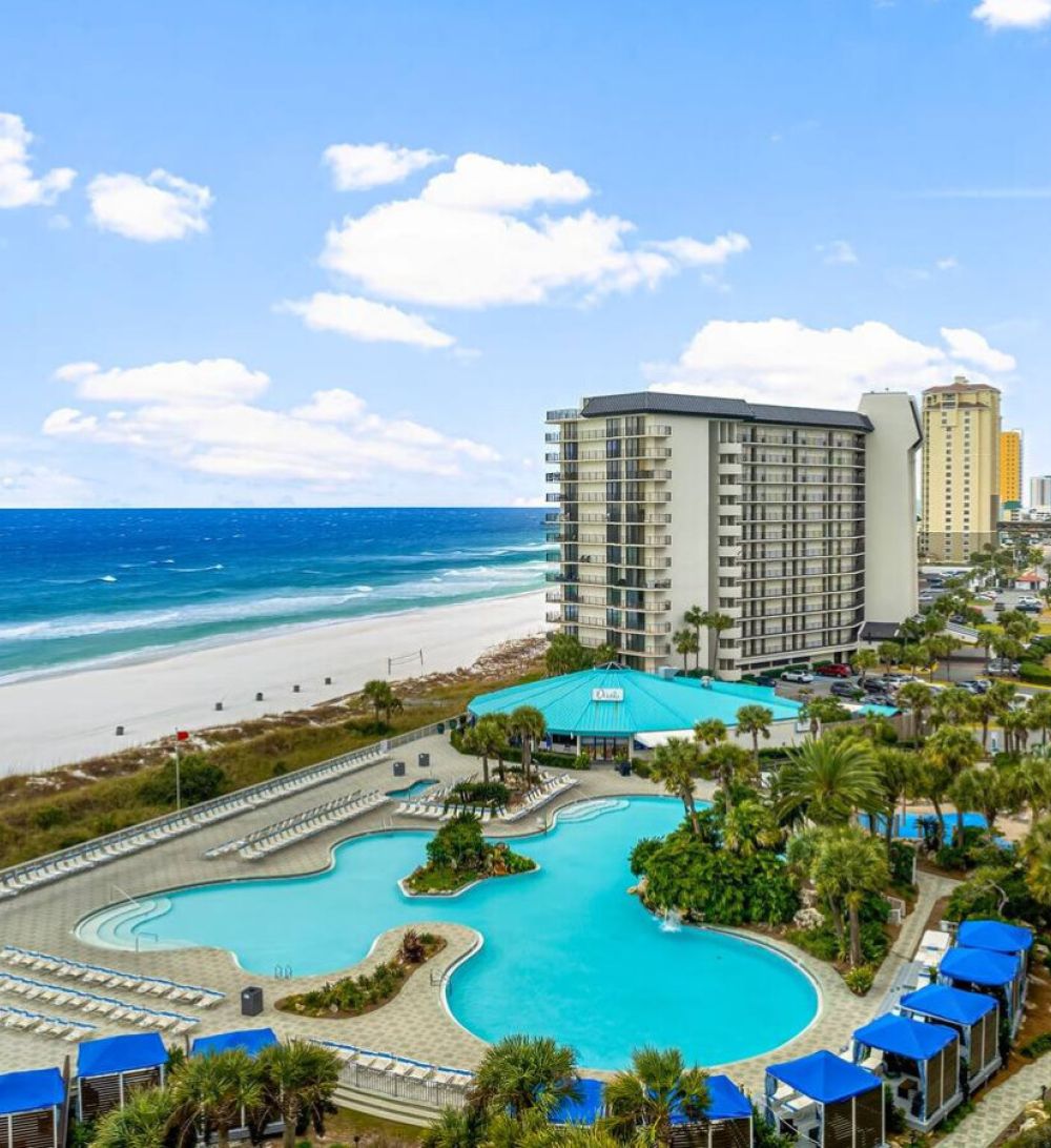 Aerial view of Edgewater Beach Resort showcasing the lagoon pool, beachfront access, and turquoise Gulf waters in Panama City Beach, Florida.