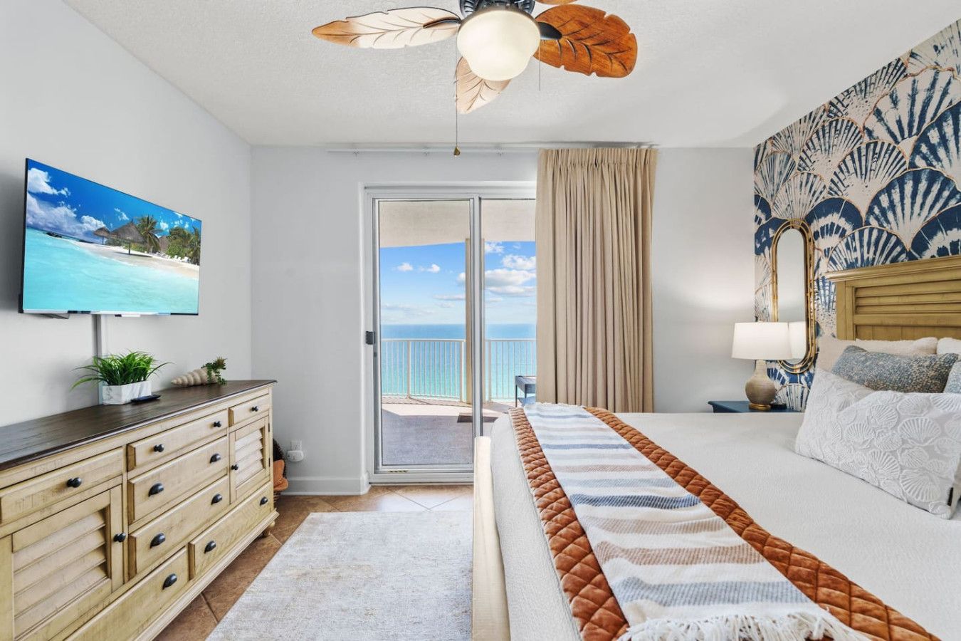 Master bedroom at Ocean Ritz Resort featuring balcony access and panoramic Gulf views.