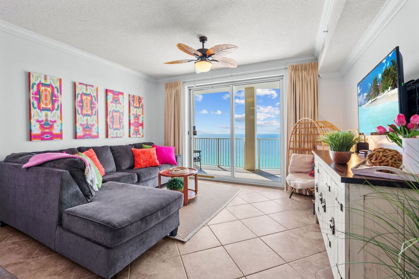 Bright living room with colorful decor and sliding doors opening to a Gulf-front balcony at Ocean Ritz Resort.