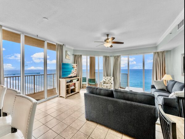 Bright living room with floor-to-ceiling windows offering sweeping Gulf views at Tidewater Beach Resort.