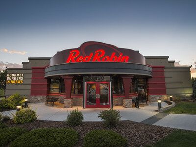Exterior view of Red Robin Gourmet Burgers and Brews in Panama City Beach with red signage and landscaped entrance.