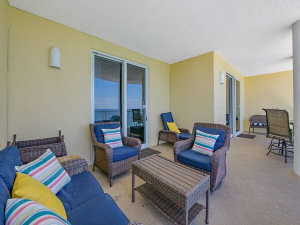 Spacious Ocean Ritz balcony with wicker lounge seating and sweeping ocean views.