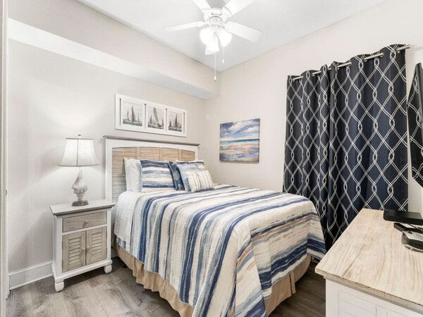 Kiddie pool area at Majestic Beach Resort with lounge chairs and palm trees under a bright blue sky.