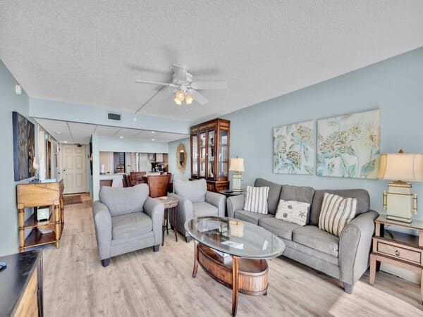 Bright and spacious living room at Edgewater Beach Resort in Panama City Beach with coastal décor, plush seating, and open layout.
