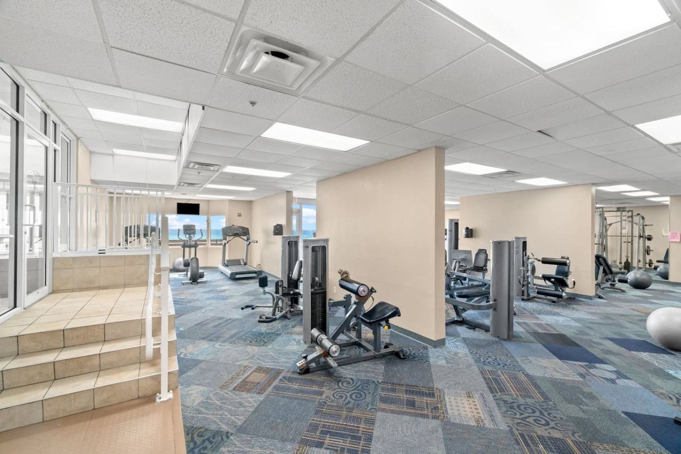 State-of-the-art fitness center at Tidewater Beach Resort with strength equipment, cardio machines, and spacious workout areas.