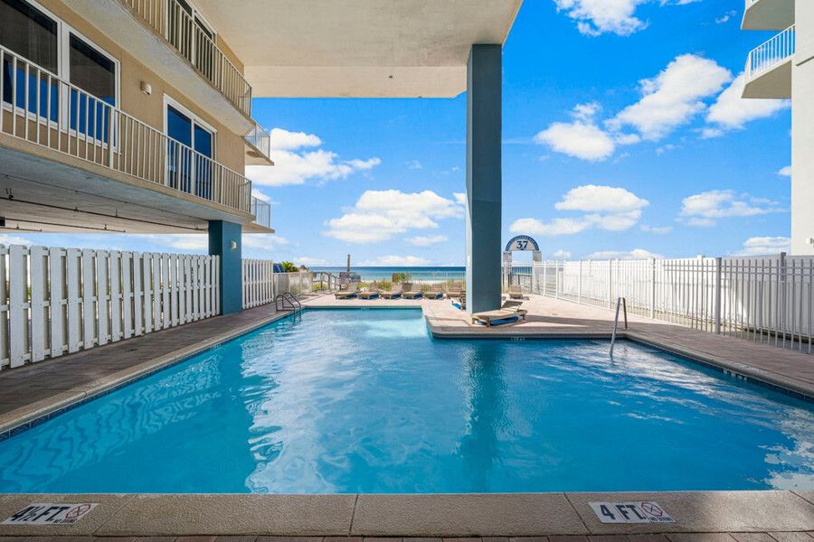 Oceanfront swimming pool and sun deck at Grandview East Resort Condo with direct beach access and Gulf of Mexico views.
