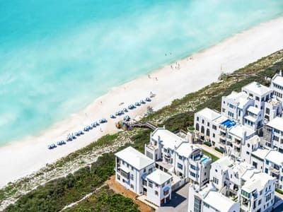 Aerial view of Alys Beach along 30A featuring turquoise water, white sand, and luxury beachfront homes.