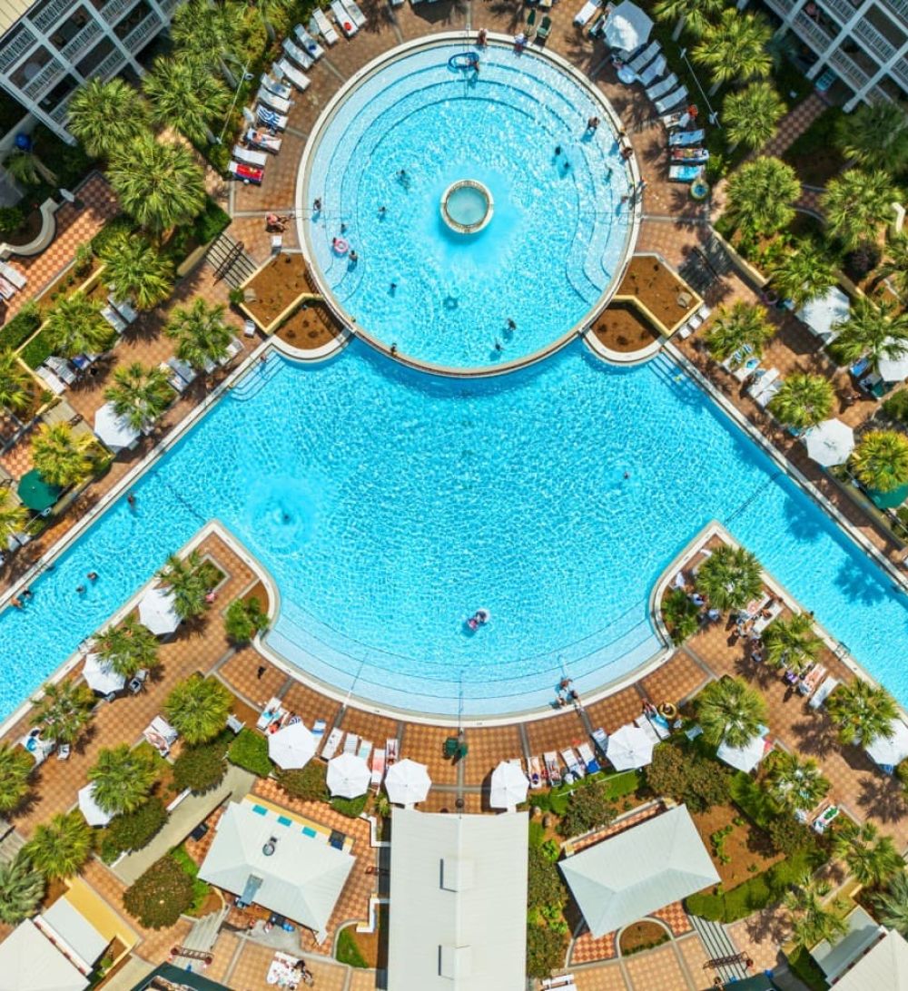 Aerial view of the Seacrest Beach 12,000-square-foot lagoon-style pool surrounded by palm trees