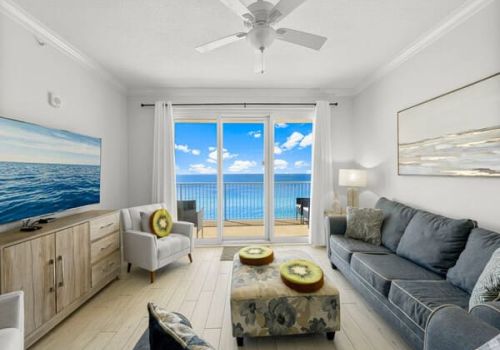Spacious master bedroom in a Seacrest Beach rental with king bed, reading nook, soft coastal tones, and private balcony access.