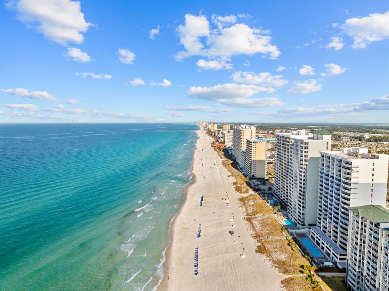 Aerial view of Panama City Beach’s coastline with emerald Gulf waters and beachfront resorts near Ocean Ritz.