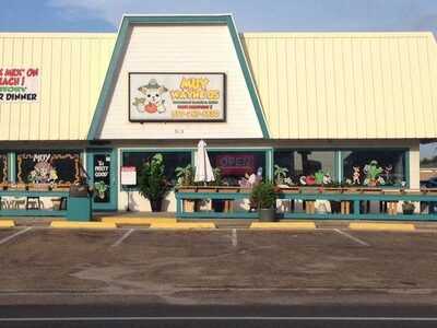 Exterior of Muy Wayne O’s Tex-Mex restaurant in Panama City Beach with colorful signage and A-frame style building.