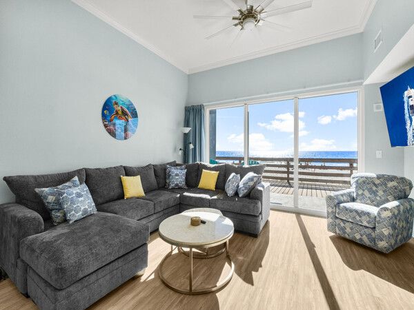 Ground-floor living room with walk-out access to the beach and direct Gulf views at Tidewater Beach Resort.