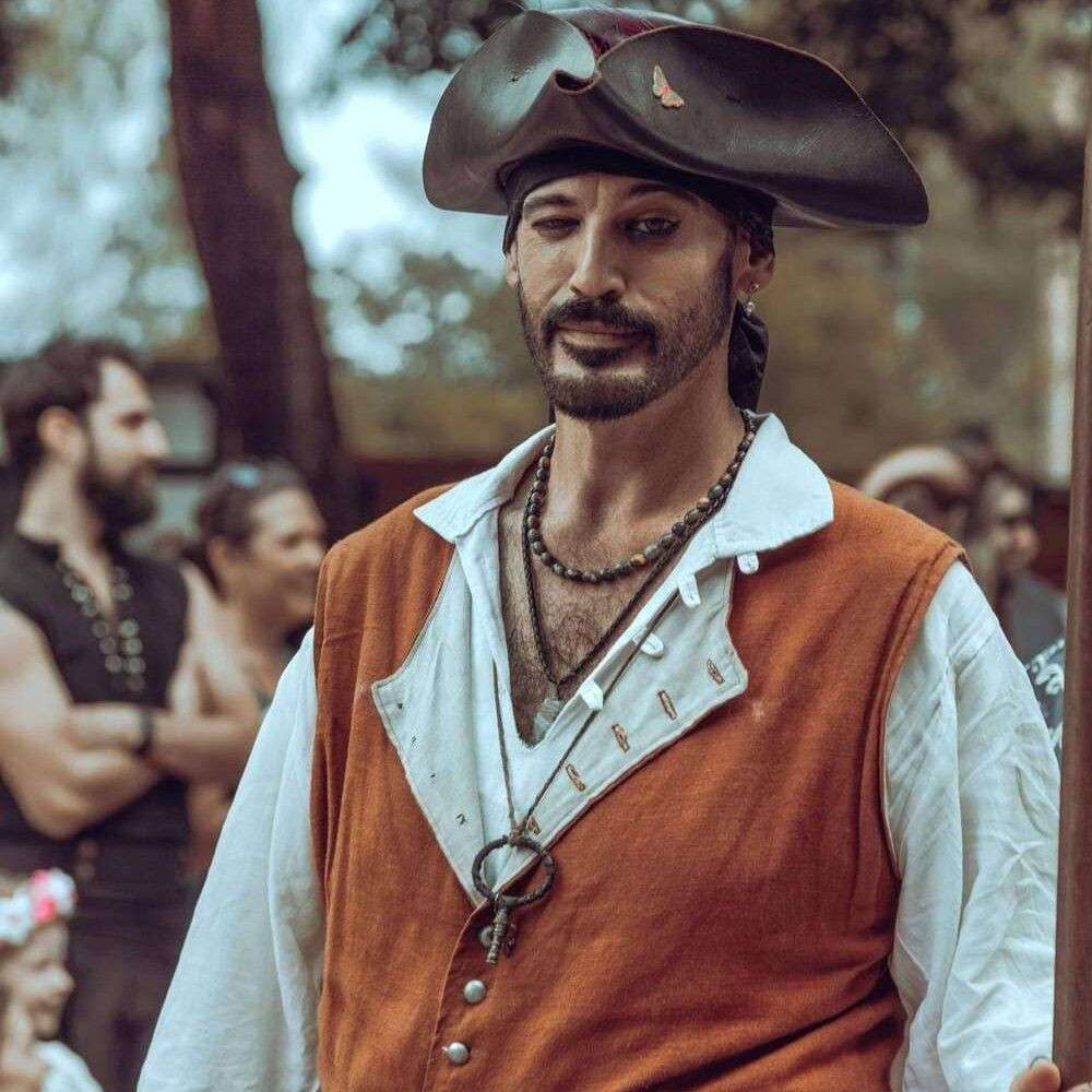 A man dressed as a pirate performs outdoors during a show.