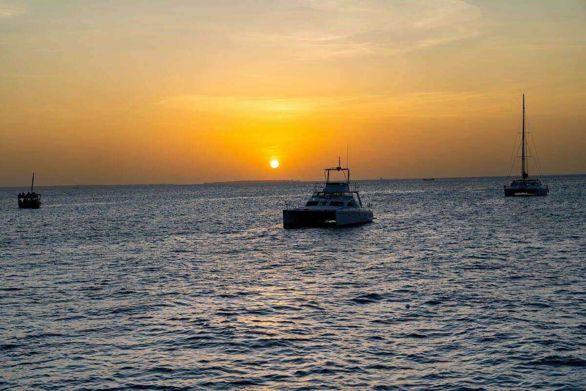A group of boats floating on top of a large body of water
